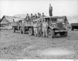 NADZAB, NEW GUINEA. 1945-10-30. LIEUTENANT D.R. BLYTON, AUSTRALIAN NEW GUINEA ADMINISTRATIVE UNIT (1), LIEUTENANT COLONEL W.J.B. MURPHY (2) AND LANCE CORPORAL R.S.G. NESBITT (3) STANDING IN FRONT ..