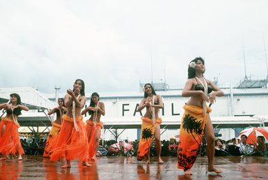 Dancers entertain visitors and crewmen of the combat stores ship USS NIAGARA FALLS (AFS 3) upon the ship's arrival at Naval Station Guam