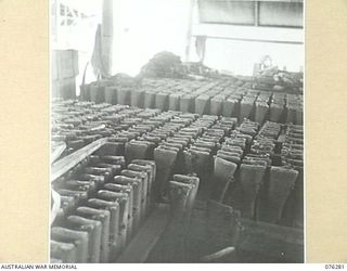 LAE, NEW GUINEA. 1944-09-27. .303 LEE ENFIELD RIFLES STACKED IN RACKS IN THE STORE OF THE 43RD FIELD ORDNANCE DEPOT