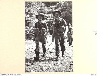 WONGINARA MISSION, NEW GUINEA. 1945-04-04. TIRED B COMPANY, 2/3 INFANTRY BATTALION TROOPS RETURNING FROM A PATROL MUDDY, WEARY, AND SOAKED TO THE SKIN. IDENTIFIED PERSONNEL ARE:- PRIVATE R.K. LAING ..