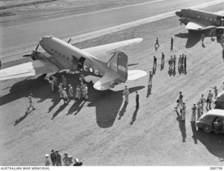 MAREEBA, QUEENSLAND. 1944-09-28. DOUGLAS C47 DAKOTA TRANSPORT AIRCRAFT OF THE RAAF LINING THE STRIP PRIOR TO DEPARTURE TO PORT MORESBY FROM HEADQUARTERS FIRST ARMY. SENIOR OFFICERS AND THEIR STAFF ..