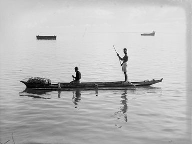 [Two men sailing in a canoe]