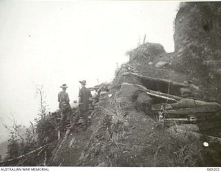 NEW GUINEA. APRIL, 1944. SERGEANT T. RAFTY, AUSTRALIAN MILITARY HISTORY SECTION (1) AND SERGEANT S. O'LEARY, DIRECTORATE OF PUBLIC RELATIONS (2) INSPECTING THE AUSTRALIAN POSITIONS AND FOX HOLES ON ..