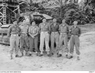 Group portrait of personnel of No. 10 Troop, B Squadron, 2/4th Armoured Regiment. Left to right: NX200774 Trooper (Tpr) E L Hunter of Young, NSW; VX63730 Tpr A E Lyon of Moulamein, NSW; NX97058 Tpr ..