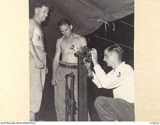 MADANG, NEW GUINEA. 1944-09-16. ARMY AND AIR FORCE BOXERS WEIGHING IN FOR THEIR FIGHT DURING A TOURNAMENT HELD AT THE 165TH GENERAL TRANSPORT COMPANY BETWEEN MEMBERS OF THE RAAF AND THE AMF. ..