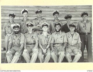 PORT MORESBY, PAPUA. 1944-07-28. STAFF OF THE RAN BASE STORE, HMAS "BASILISK". IDENTIFIED PERSONNEL ARE:- PETTY OFFICER HONEYSETT (1); PAY SUB LIEUTENANT J. BALMER (2); PAY LIEUTENANT T.W. SLADE ..