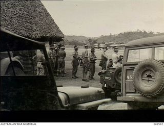 Port Moresby, New Guinea. 1944-01-06. Outside the Air Transport Control Hut at Wards Airfield, where New Guinea Force officers control the movement of aircraft to all parts of the South West ..