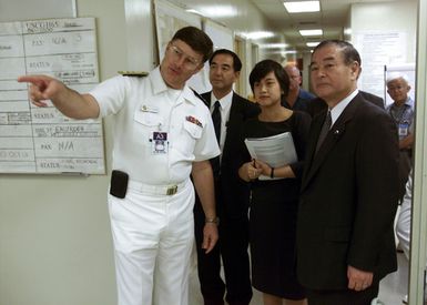 US Navy (USN) Rear Admiral (RADM) William R. Klemm (left), Project Coordinator for the Ehime Maru Recovery Operations, shows Toshio Kojima, Parliamentary Secretary of Japan, the inner workings or the Ehime Maru Command Center (EMCC) during the Secretary's official visit to Hawaii (HI)