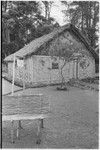 Edwin Cook's house in Kwiop with sign advertising Cook's services as a resident anthropologist