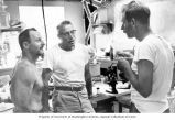 Lauren R. Donaldson, center, and colleagues discuss a research problem at the Eniwetok Marine Biological Laboratory, summer 1964