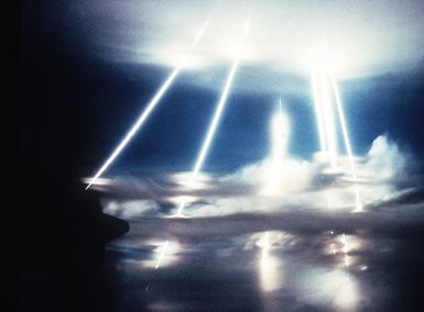 MX intercontinental ballistic missile re-entry vehicles pass through the clouds after a 4,130 nautical mile flight from Vandenberg Air Force Base, Calif