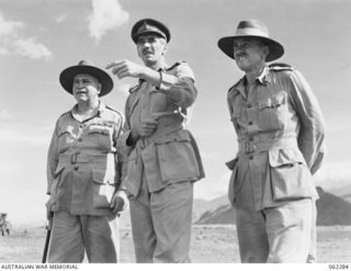 DUMPU, NEW GUINEA. 1943-12-19. VX9 MAJOR GENERAL G. A. VASEY, CB., CBE., DSO., GENERAL OFFICER COMMANDING 7TH AUSTRALIAN DIVISION (2) POINTS OUT THE AUSTRALIAN POSITIONS IN THE FINISTERRES TO VX1 ..