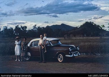 Family and car, mountains in distance