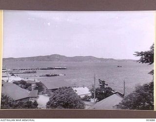 PORT MORESBY HARBOUR FROM AIR FORCE HEADQUARTERS. ENTRANCE AT LEFT. RAAF SURVEY FLIGHT. (NEGATIVE BY N. TRACY)