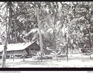 RABAUL, NEW BRITAIN, 1945-12-12. THE OFFICERS' MESS SET AMONG PALMS IN 28TH INFANTRY BATTALION CAMP AREA