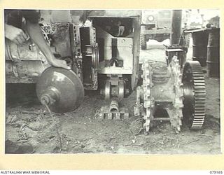 TOROKINA, BOUGAINVILLE ISLAND. 1945-02-21. A DRIVING SPROCKET REMOVED FROM A "MATILDA" TANK OF B SQUADRON, 2/4TH ARMOURED REGIMENT SHOWING THE EFFECTIVENESS OF A NEW SPROCKET SCRAPER NOW FITTED. ..