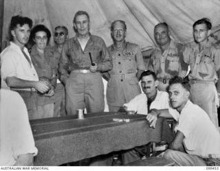 LAE, NEW GUINEA, 1945-12-25. THE RIGHT HONOURABLE J. B. CHIFLEY, PRIME MINISTER OF AUSTRALIA AND MAJOR-GENERAL H. C. H. ROBERTSON, GENERAL OFFICER COMMANDING 6 DIVISION, PHOTOGRAPHED WITH PATIENTS ..