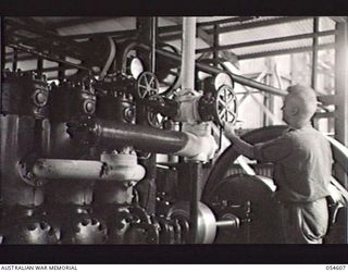 MILNE BAY, NEW GUINEA, 1943-07-11. N229340 CORPORAL W. GARROD, CORPORAL IN CHARGE OF THE ERECTION OF THE ICE WORKS AT WAIGANI