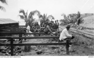 KABAKAUL, NEW GUINEA. 1914-09. WAITING TO REEMBARK AFTER THE FIGHT AGAINST THE GERMANS ON THE BITA PAKA ROAD. COMMANDER CUMBERLEGE RN IS IN THE FOREGROUND. (DONOR LT.-COM. G.A. HILL, RNR.)