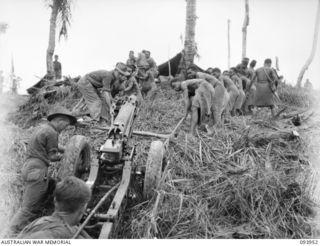 ULUPU, NEW GUINEA, 1945-07-09. A 75 MILLIMETRE GUN OF 2/1 TANK ATTACK REGIMENT BEING HAULED ALONG ULUPU RIDGE BY 30 NATIVES. IT WAS MANNED BY 18 PLATOON, D COMPANY, 2/5 INFANTRY BATTALION WHO ..