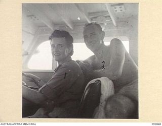 JACQUINOT BAY AREA, NEW BRITAIN. 1945-05. LIEUTENANT BURKEHARDT, 594 ENGINEER BOAT AND SHORE REGIMENT (2), TEACHES SISTER M. O'LOUGHLIN, AUSTRALIAN ARMY NURSING SERVICE, 105 CASUALTY CLEARING ..