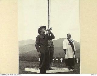 DUMPU, NEW GUINEA. 1944-02-06. VX60598 PRIVATE V. DAVIS (3) SOUNDING THE "LAST POST" AT THE DEDICATION SERVICE OF THE DUMPU WAR CEMETERY. THE SERVICE WAS JOINTLY CONDUCTED BY VX39632 CHAPLAIN F.J. ..