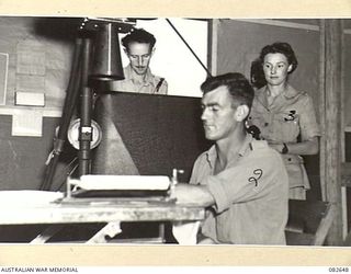 LAE AREA, NEW GUINEA. 1944-11-06. CORPORAL E.M. BIRCHALL (3), OPERATING THE X-RAY PLANE TO PHOTOGRAPH A HAND INJURY ON A PATIENT AT THE 2/7 GENERAL HOSPITAL. AMONG OTHER DUTIES, AUSTRALIAN ARMY ..