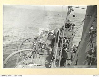 MADANG, NEW GUINEA. 1944-10-30. THE MAIN ARMAMENT BEING FIRED DURING A PRACTICE SHOOT ABOARD THE RAN SLOOP, SWAN