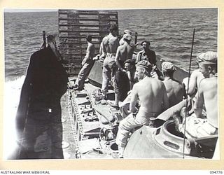 TOROKINA AREA, BOUGAINVILLE, 1945-08-06. AUSTRALIAN LANDING CRAFT 40 WITH TWO M24 GENERAL CHAFFEE, LIGHT TANKS ABOARD HEADS OUT TO SEA, DURING TRIALS CONDUCTED FOR THE WAR OFFICE