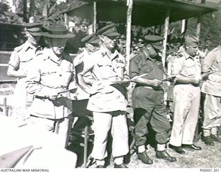 THE SOLOMON ISALNDS, 1945-08. A GROUP OF SERVICE OFFICERS AND BRITISH ENTERTAINER GRACIE FIELDS AT A THANKSGIVING SERVICE ON BOUGAINVILLE ISLAND. (RNZAF OFFICIAL PHOTOGRAPH.)