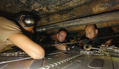 U.S. Air Force SENIOR AIRMAN Anthony Wilson (left), and SENIOR AIRMAN Larry Jerson (center), both from the 734th Air Mobility Squadron (AMS), Anderson Air Force Base, Guam, and TECH. SGT. Joon Hong, from the 615th Air Mobility Squadron, Travis Air Force Base, Calif., tie down a trailer inside an aircraft during Operation Unified Assistance at Utapao Air Base, Thailand, on Jan. 9, 2005. More than 18,000 U.S. military personnel are providing humanitarian assistance in Southwest Asia after a 9.0 magnitude earthquake on Dec. 26, 2004, triggered devastating tsunamis that killed over 250,000 people in the region. (USAF PHOTO by STAFF SGT. Sarayuth Pinthong) (Released)