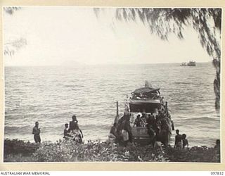 KAHILI, BOUGAINVILLE. 1945-10-08. NATIVES UNLOADING STORES FROM AN AUSTRALIAN LANDING CRAFT OF 42 LANDING CRAFT COMPANY. THESE STORES WERE TRANSPORTED FROM TOROKINA TO THE BUIN AREA BY THE 300-TON ..
