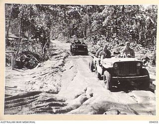 BOUGAINVILLE, 1945-07-16. A GENERAL VIEW SHOWING THE CONDITION OF THE BUIN ROAD, THE MAIN SUPPLY ROUTE TO FORWARD TROOPS OF HQ 29 INFANTRY BRIGADE. COMPARE WITH NO. 94057 WHICH SHOWS IMPROVEMENTS ..