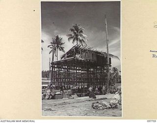 MUSCHU ISLAND, NEW GUINEA. 1945-10-10. THE WATER TOWER THAT THE JAPANESE HAVE CONSTRUCTED TO SUPPLY WATER FOR THE HOSPITAL ESTABLISHED AT THE BEACHHEAD. THE EQUIPMENT AND ENGINEERING TOOLS WERE ..