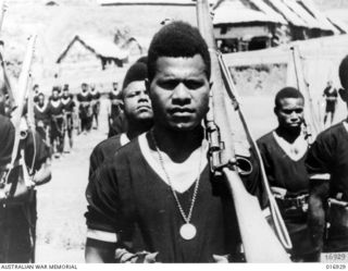 New Guinea. 1944-04. Constable Sikomi of the Royal Papuan Constabulary wearing the Loyal Service Medal for service against the Japanese