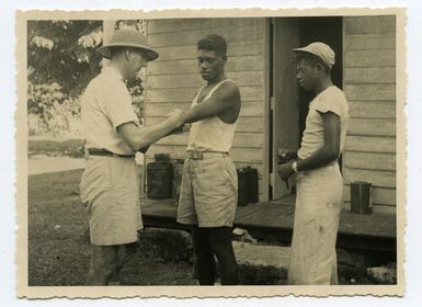 Rev. C. K. Crump giving an injection for yaws