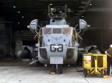 A CH-53E Super Stallion helicopter from HMH-463 Kaneohe Bay, Hawaii, that was disassembled so it could be transported to Anderson Air Force Base, Guam, waits to be put back together during Exercise KOA THUNDER 2001 at Anderson Air Force Base. Marines from Aviation Support Element, Kaneohe Bay, Hawaii, 1ST Marine Air Wing, Okinawa, Japan, and 3rd Marines 7th Battalion, 29 Palms, California, participated in KOA THUNDER on the island of Guam from July 9 to July 14. The purpose of the exercise was to demonstrate the Marine Corps' ability to deploy in the South Pacific from places other than Okinawa, Japan