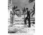 CAPT Christian L. Engleman and Edward H. Shuler standing beside Japanese monument, Bikini Island, summer 1947