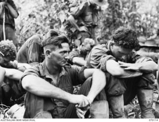 KETOBA, NEW GUINEA. 1944-01-29. PRIVATE A.N. BENNEWORTH (1) AND CORPORAL D.T.T. BOURKE (2) OF THE 57/60TH INFANTRY BATTALION AT AN IMPROMPTU PRAYER MEETING HELD ON THE EDGE OF A SMALL STREAM NOT ..