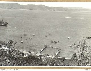 PORT MORESBY, NEW GUINEA. 1943-12-29. SWIMMING BATHS AND THE SMALL SHIPS ANCHORAGE IN THE HARBOUR. BUILDING IN THE IMMEDIATE FOREGROUND IS THE PORT MORESBY POWERHOUSE