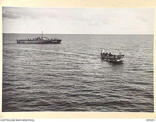 AT SEA, OFF BUIN, BOUGAINVILLE. 1945-08-20. A JAPANESE BARGE CARRYING ENVOY FROM LIEUTENANT GENERAL M. KANDA, COMMANDER IMPERIAL JAPANESE 17 ARMY GROUP, ESCORTED BY RAN MOTOR LAUNCHES, APPROACHING ..