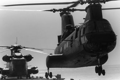 A CH-46 Sea Knight helicopter takes off from the flight deck of the amphibious assault ship USS GUAM (LPH 9), during operations off the coast of Beirut, Lebanon. Behind the Sea Knight is a CH-53 Sea Stallion helicopter