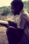 Missionary's trainee reading the New Testament in Pidgin English (Tok Pisin)