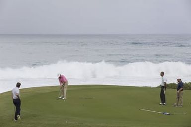 Barack Obama plays golf with Prime Minister Najib Razak, Joe Paulsen, and Mike Brush in Kaneohe Bay, Hawaii, December 24, 2014