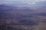 Aerial view of ridge-top hamlet, the nearby road means an end to centuries of isolation, Eastern Highlands, [Papua New Guinea, 1963?]