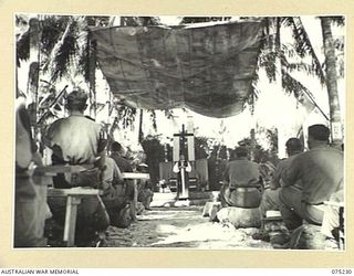 NORTH ALEXISHAFEN, NEW GUINEA. 1944-08-10. VX20306 CHAPLAIN GENERAL C.L. RILEY, CBE, VD, BISHOP OF BENDIGO, VICTORIA, HEADQUARTERS, NEW GUINEA FORCE, PREACHING HIS SERMON AT THE CONCLUSION OF THE ..