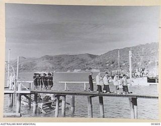 PORT MORESBY - NATIVE CONSTABULARY BEARING SIR HUBERT MURRAY'S COFFIN TO AIR FORCE TRAILER, AFTER BEING FLOWN FROM SAMARAI. (NEGATIVE BY N. TRACY)