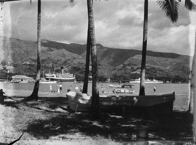 [Pacific Island waterfront scene with people, boats and ships]