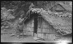 Woman in front of dwelling