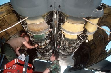 A maintenance team from the 320th Bomb Wing repairs an engine on a B-52 Stratofortress aircraft during exercise Giant Warrior '89